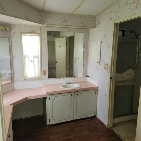 a bathroom with a sink double vanity and a mirror