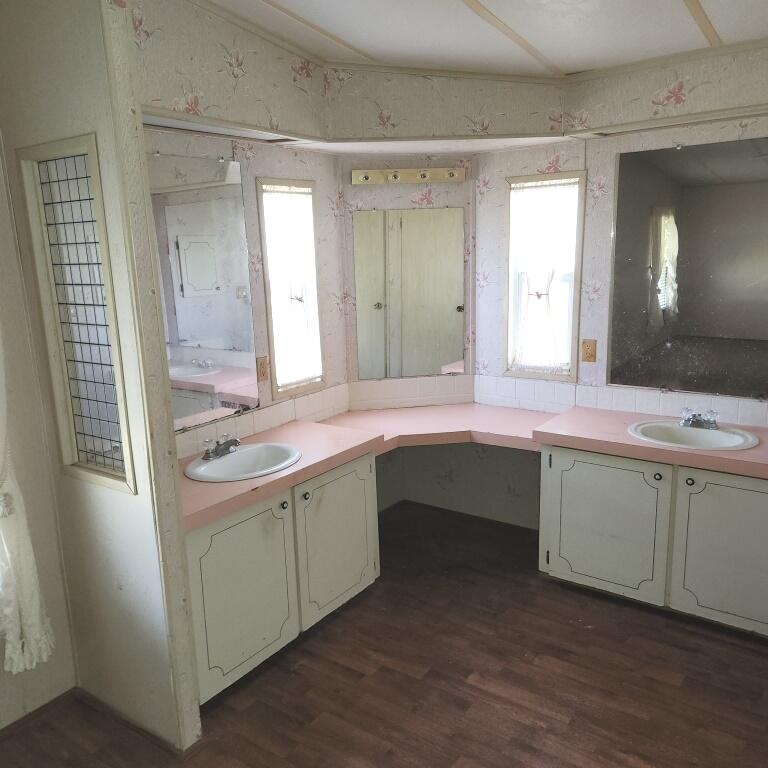 2847 Southwest Thunderbird Trail Stuart, FL 34997 - Photo 18 of 22 a bathroom with a sink double vanity and a mirror