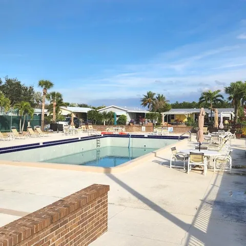 a view of a big house in a big yard with large trees