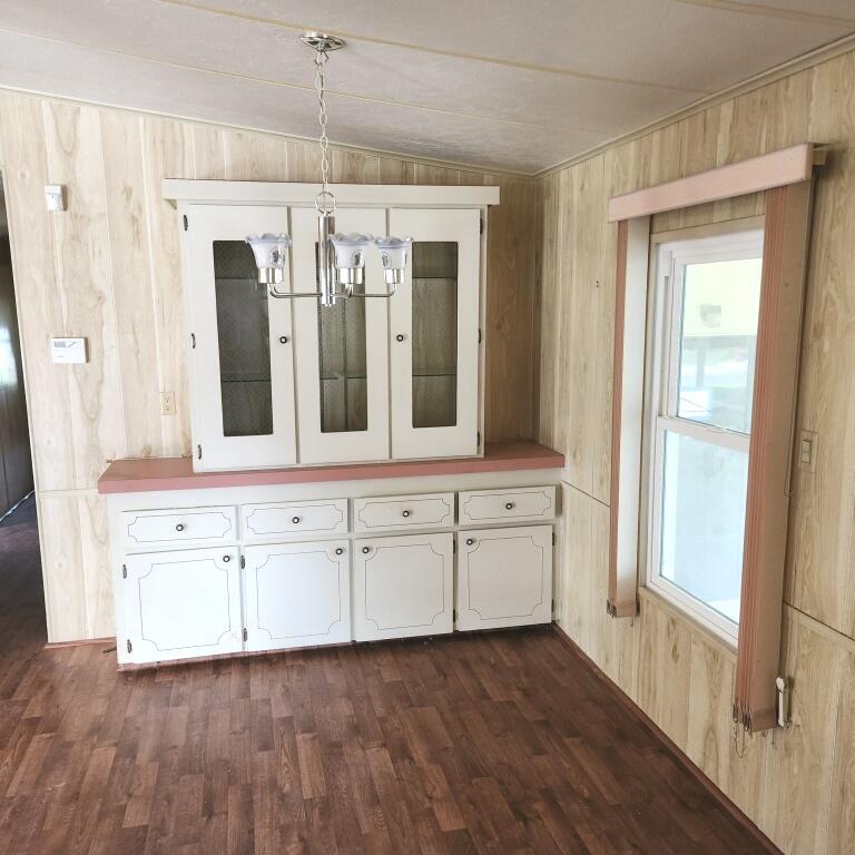 2847 Southwest Thunderbird Trail Stuart, FL 34997 - Photo 7 of 22 a view of a hallway with chandelier and wooden floors