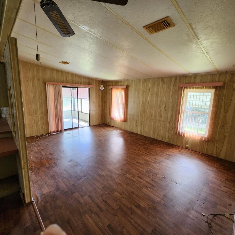 2847 Southwest Thunderbird Trail Stuart, FL 34997 - Photo 10 of 22 an empty room with wooden floor and windows