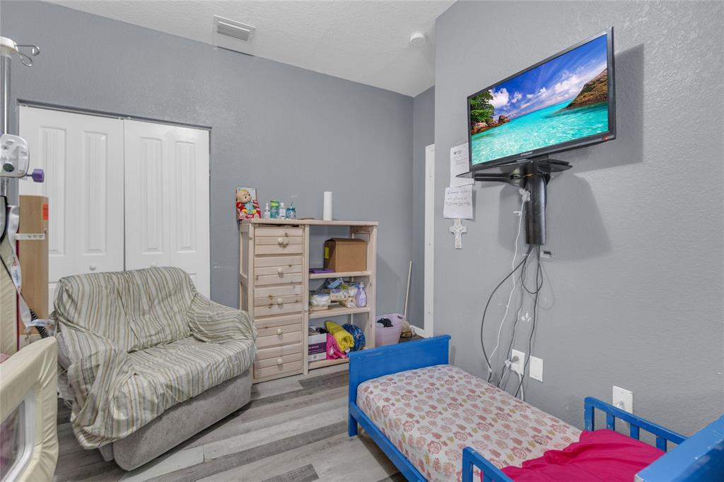 11050 Southwest 225th Terrace Miami, FL 33170 - Photo 19 of 30 a living room with furniture and a flat screen tv