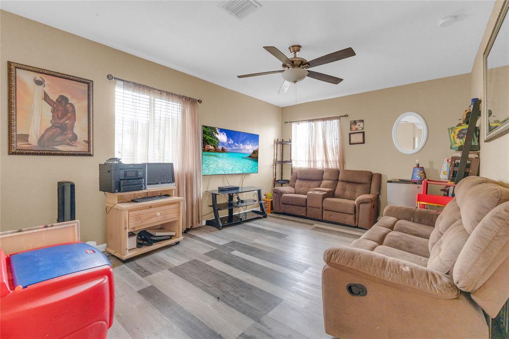 11050 Southwest 225th Terrace Miami, FL 33170 - Photo 25 of 30 a living room with furniture and a flat screen tv