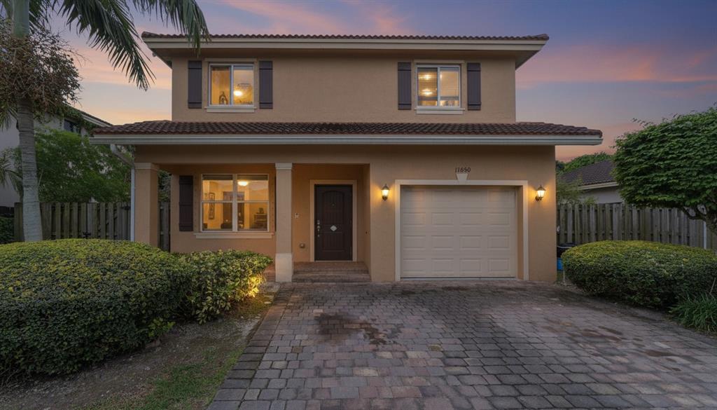 11050 Southwest 225th Terrace Miami, FL 33170 - Photo 3 of 30 a front view of a house with a yard