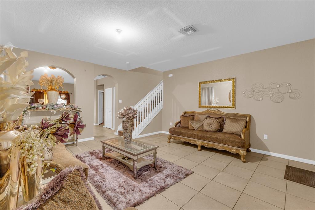 11050 Southwest 225th Terrace Miami, FL 33170 - Photo 8 of 30 a living room with furniture and a rug