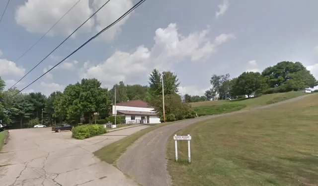 a view of a bench in a backyard of house