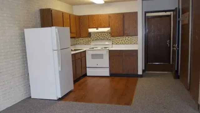 a kitchen with a refrigerator and a stove