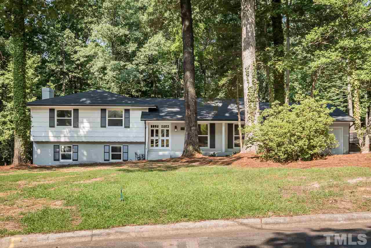 4008 Oak Park Road Raleigh, NC 27612 - Photo 1 of 24 a view of house with yard outdoor seating and covered with trees