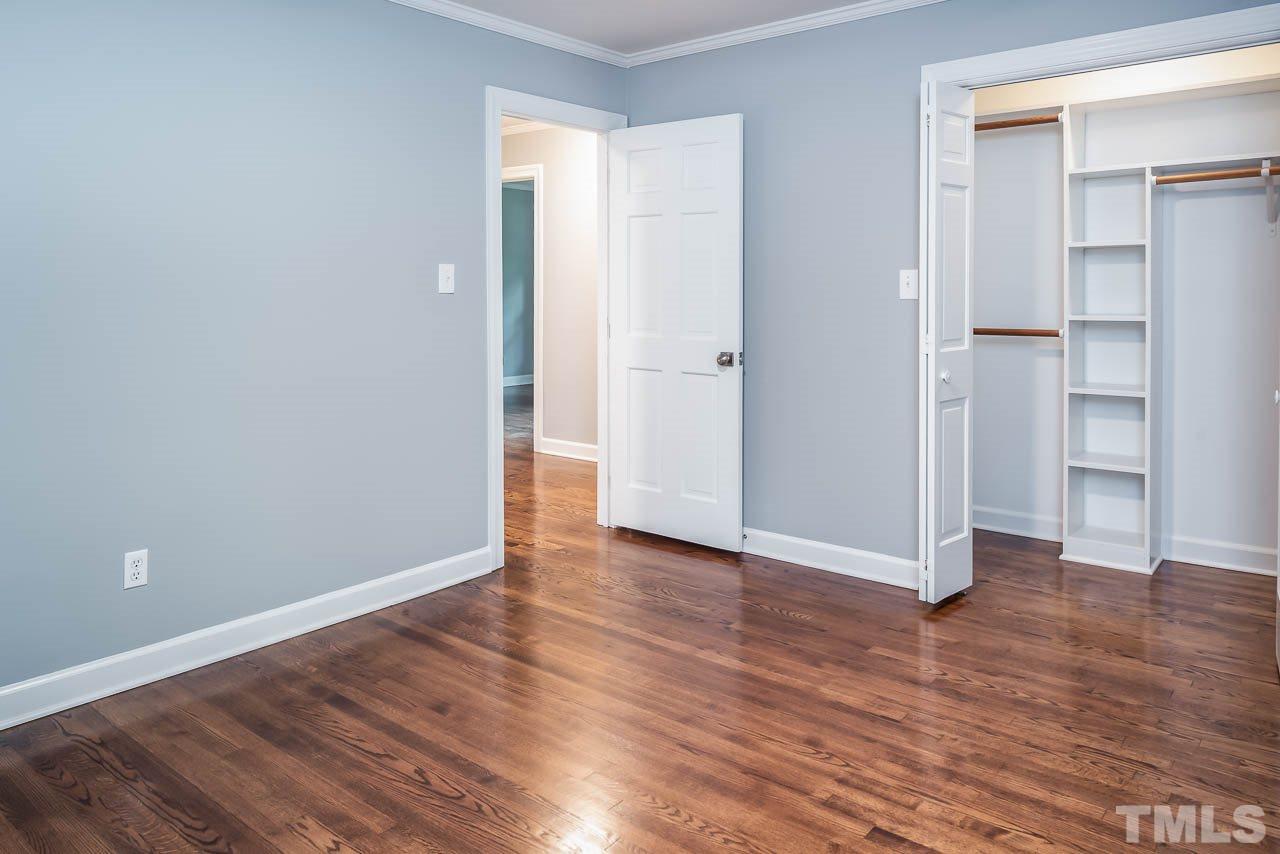 4008 Oak Park Road Raleigh, NC 27612 - Photo 10 of 24 a view of an empty room with wooden floor and closet