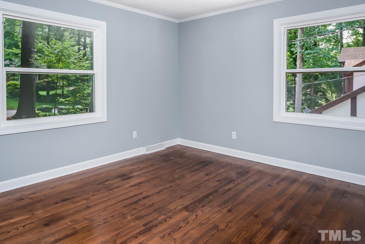 4008 Oak Park Road Raleigh, NC 27612 - Photo 11 of 24 a view of an empty room with wooden floor and a window