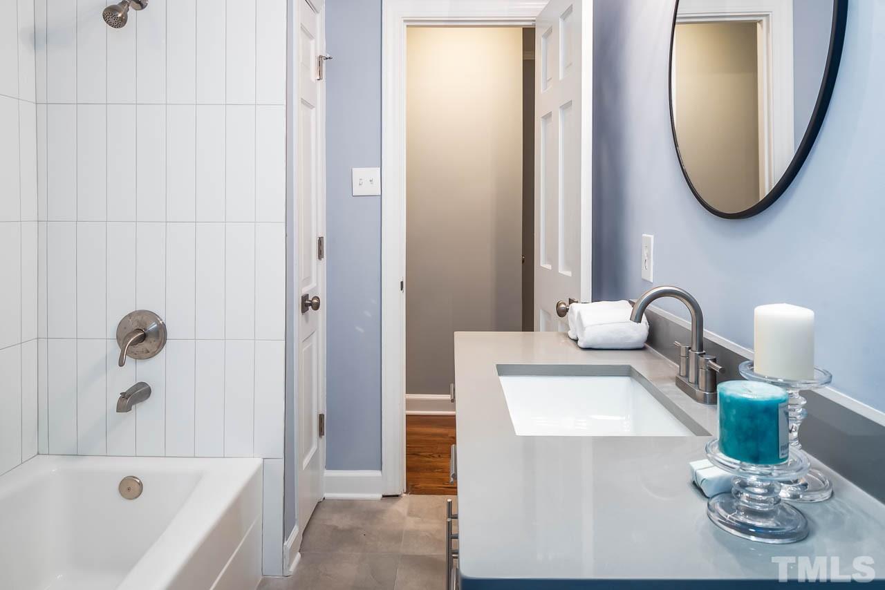 4008 Oak Park Road Raleigh, NC 27612 - Photo 13 of 24 a bathroom with a sink and a mirror