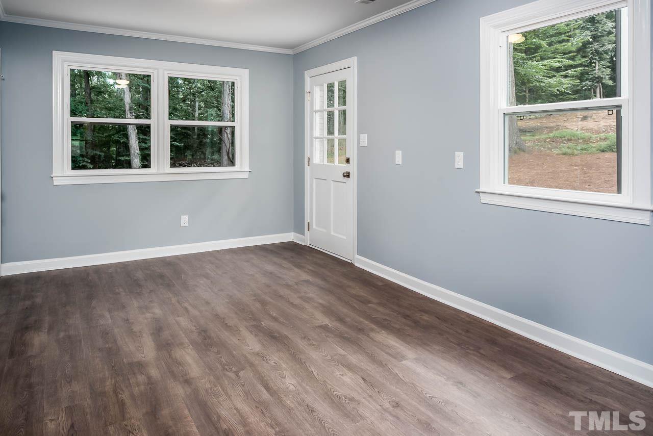 4008 Oak Park Road Raleigh, NC 27612 - Photo 16 of 24 an empty room with wooden floor and windows