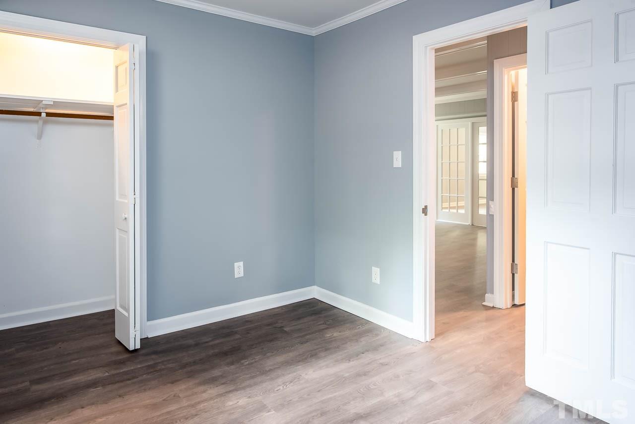 4008 Oak Park Road Raleigh, NC 27612 - Photo 19 of 24 an empty room with wooden floor and a window