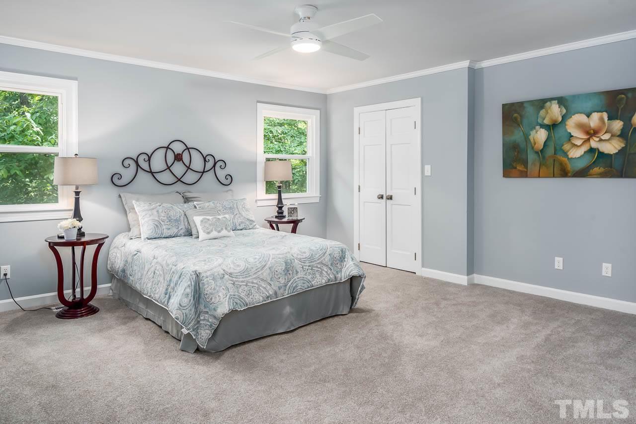 4008 Oak Park Road Raleigh, NC 27612 - Photo 7 of 24 a bedroom with a bed and a painting on the wall