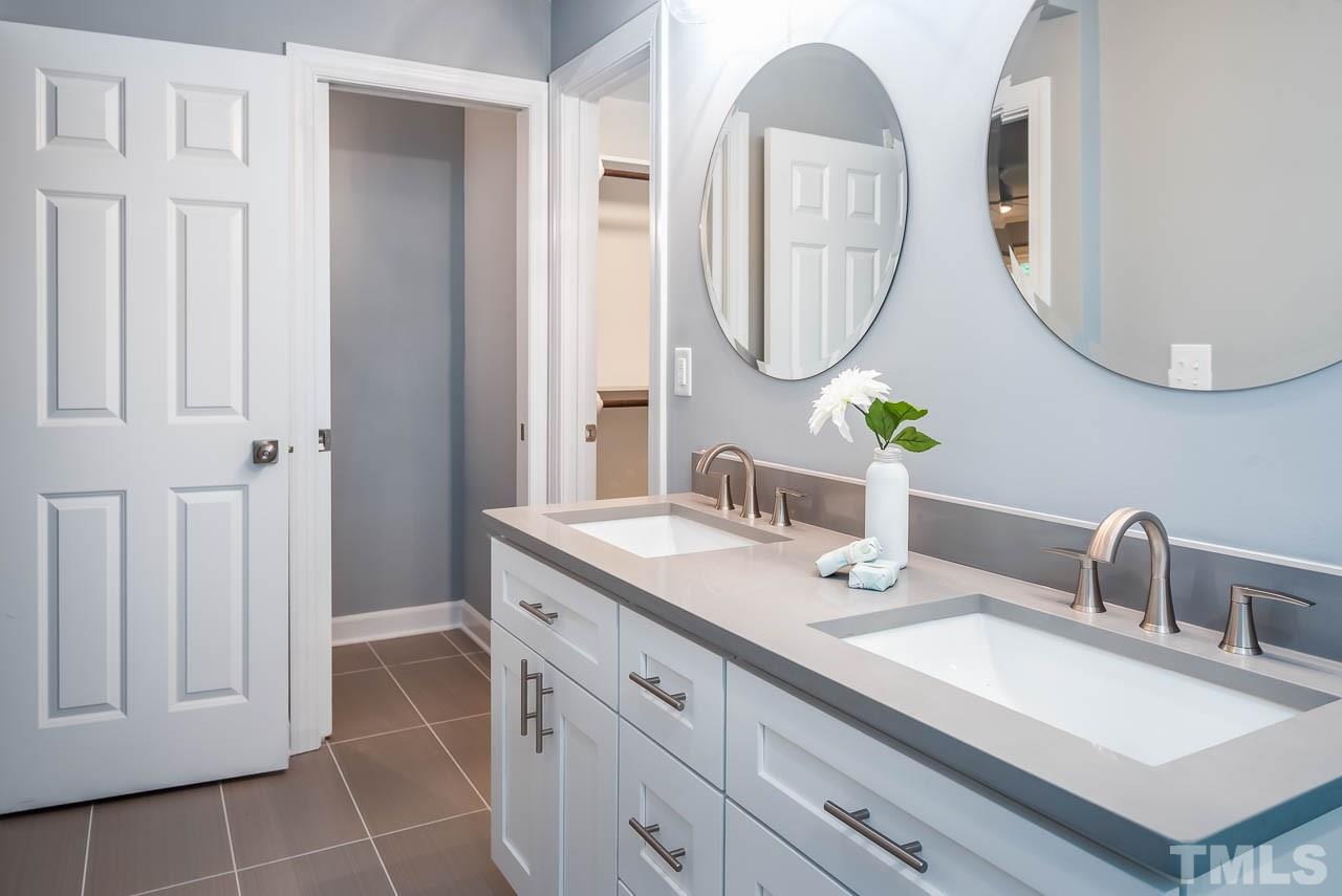 4008 Oak Park Road Raleigh, NC 27612 - Photo 9 of 24 a bathroom with a sink vanity and a mirror