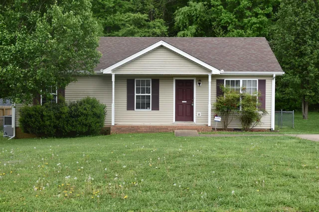 a view of a house with a yard and plants
