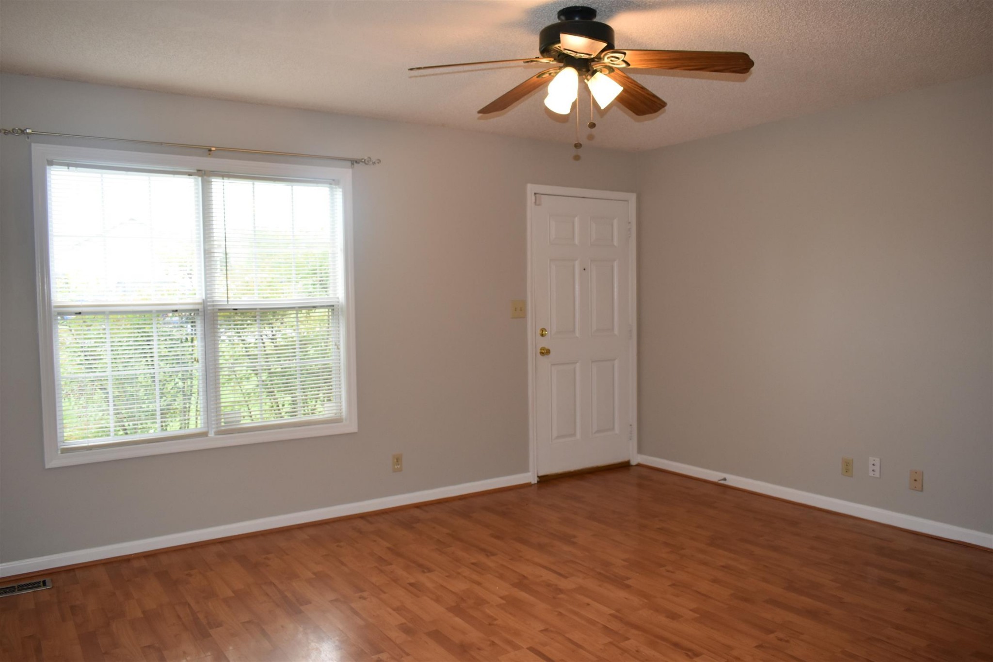 153 Monarch Lane Clarksville, TN 37042 - Photo 4 of 11 a view of an empty room with wooden floor and a window