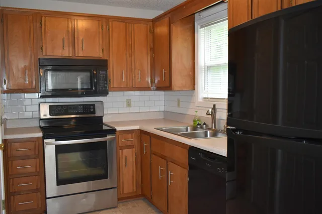 a kitchen with a stove microwave and sink