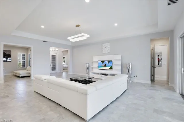 a bedroom with a large bed and a chandelier