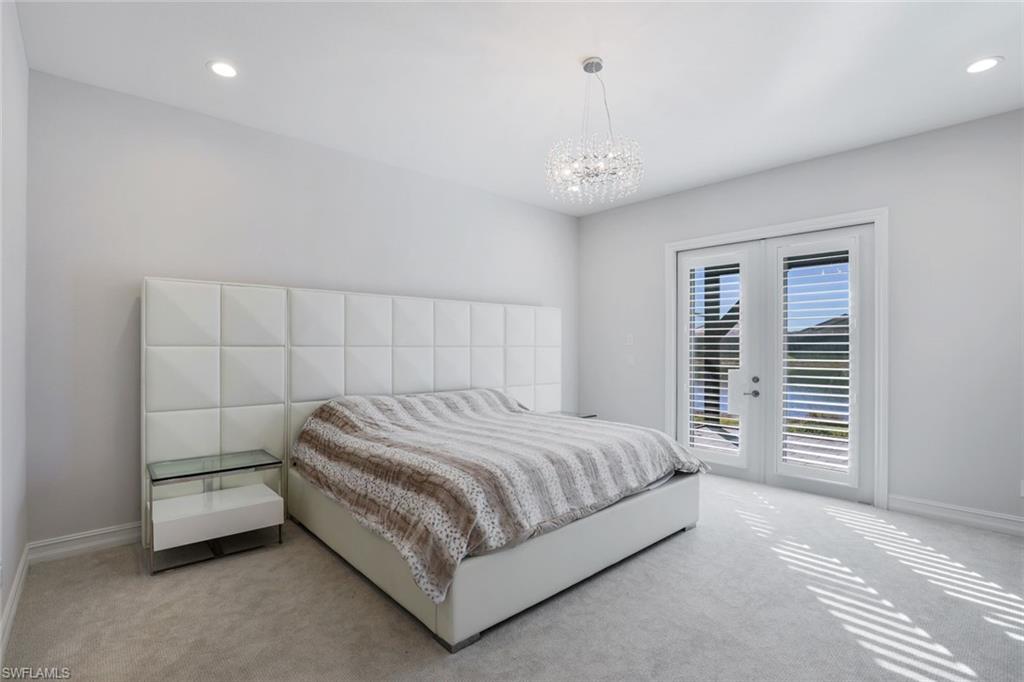 14327 Laguna Springs Lane Naples, FL 34114 - Photo 13 of 35 a bedroom with a bed and a window