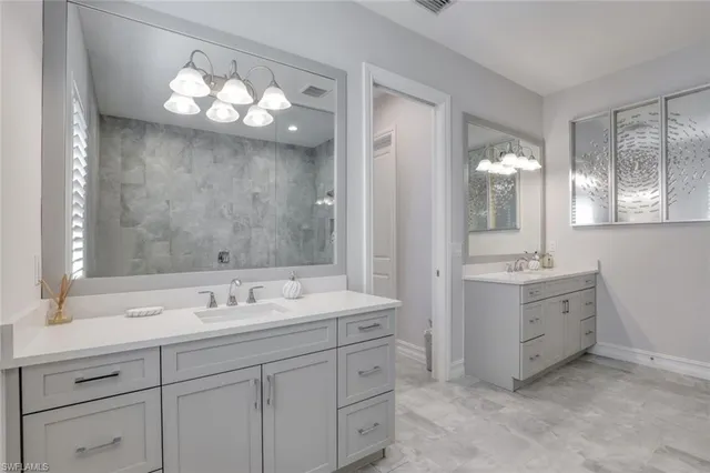 a large bed sitting in a bedroom next to a window