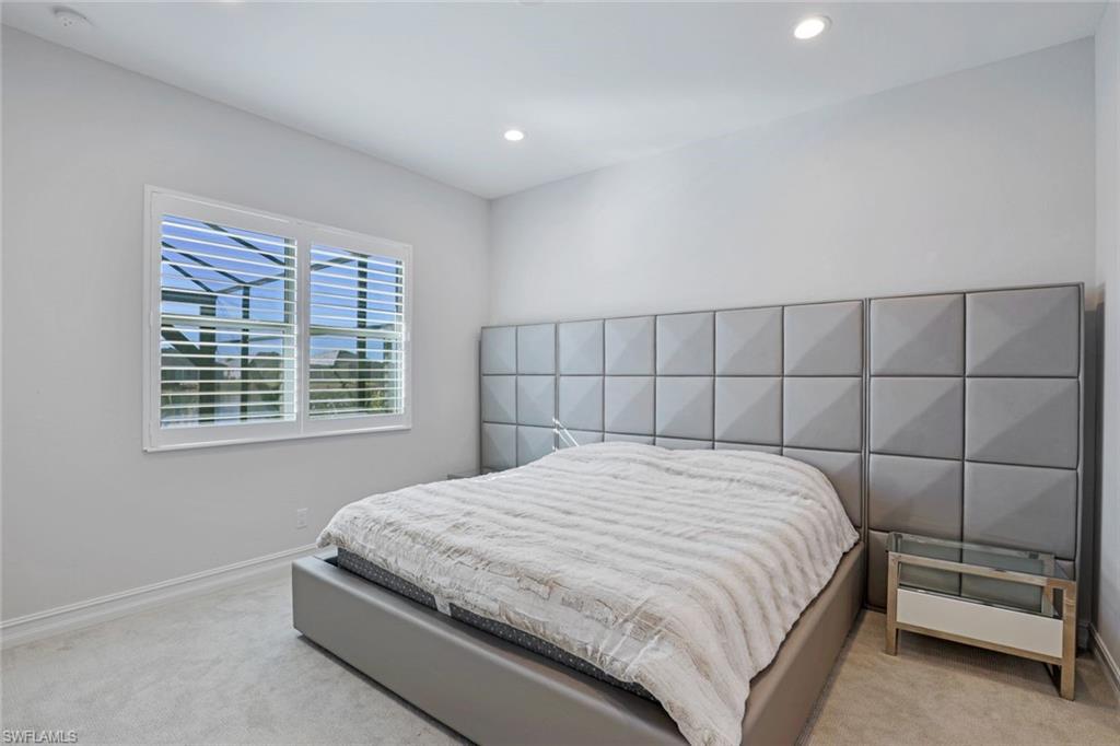 14327 Laguna Springs Lane Naples, FL 34114 - Photo 17 of 35 a bedroom with a bed and a window