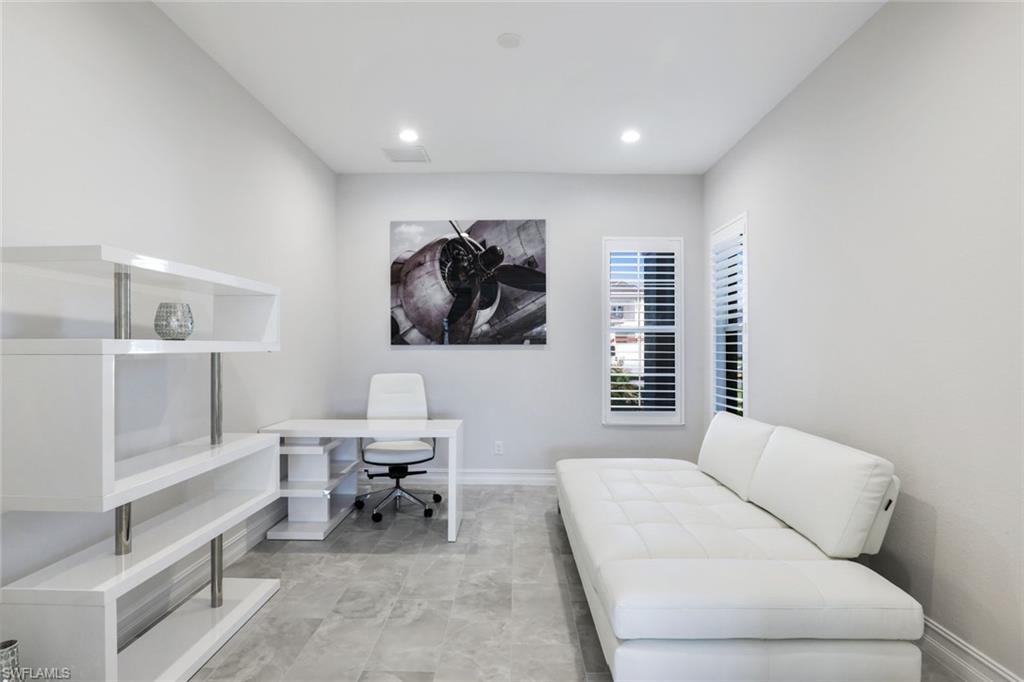 14327 Laguna Springs Lane Naples, FL 34114 - Photo 22 of 35 a living room with furniture and a window