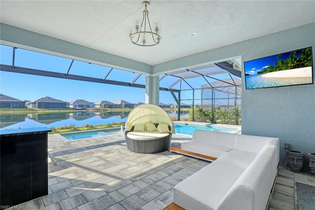 14327 Laguna Springs Lane Naples, FL 34114 - Photo 24 of 35 a living room with a couch and a table