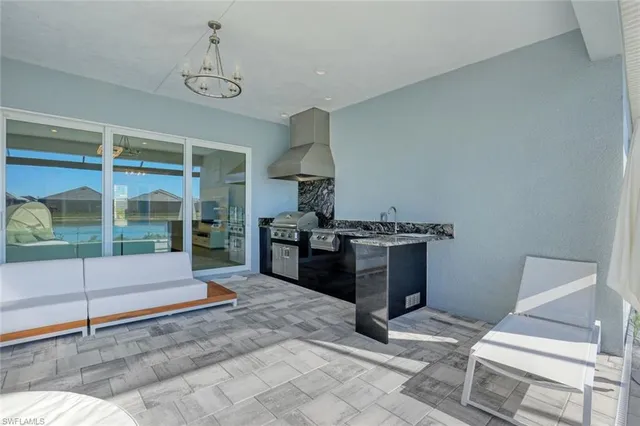 a view of a house with backyard porch and sitting area