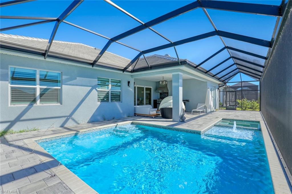 14327 Laguna Springs Lane Naples, FL 34114 - Photo 27 of 35 a view of a house with backyard porch and sitting area