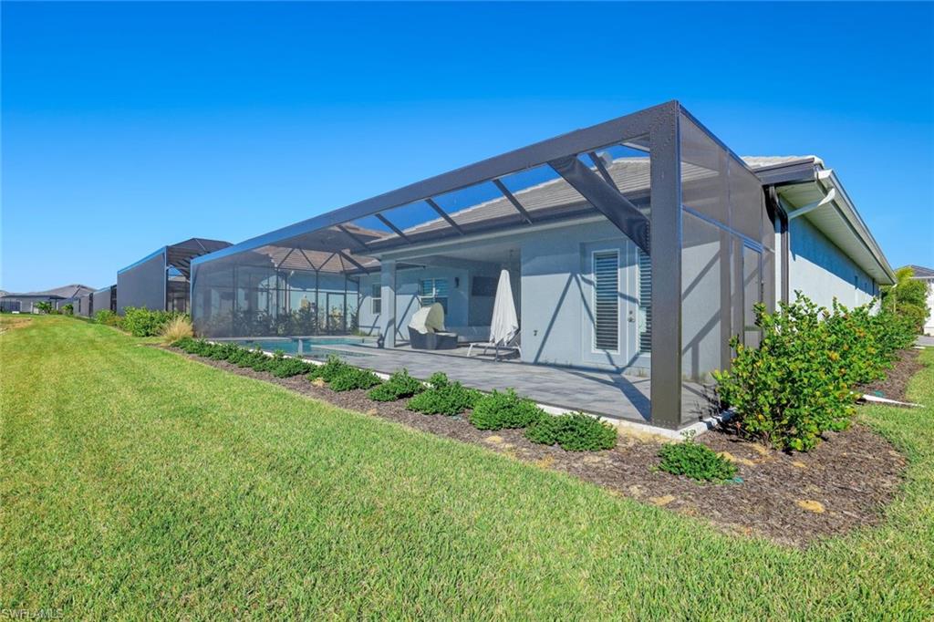 14327 Laguna Springs Lane Naples, FL 34114 - Photo 29 of 35 a front view of a house with garden