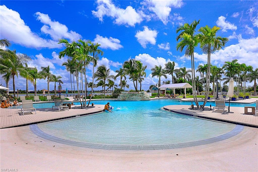 14327 Laguna Springs Lane Naples, FL 34114 - Photo 31 of 35 a view of a swimming pool with lounge chairs