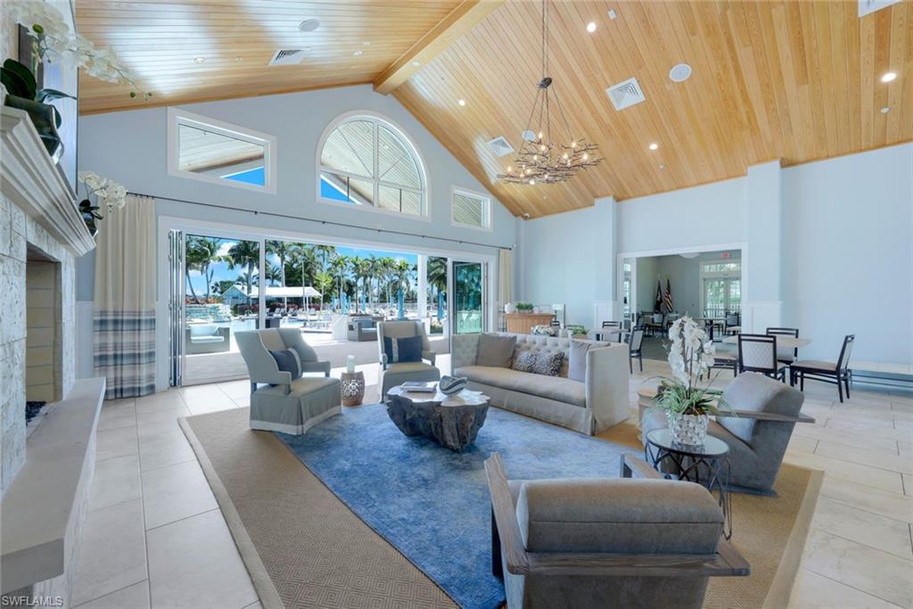 14327 Laguna Springs Lane Naples, FL 34114 - Photo 32 of 35 a living room with lots of furniture and a large window