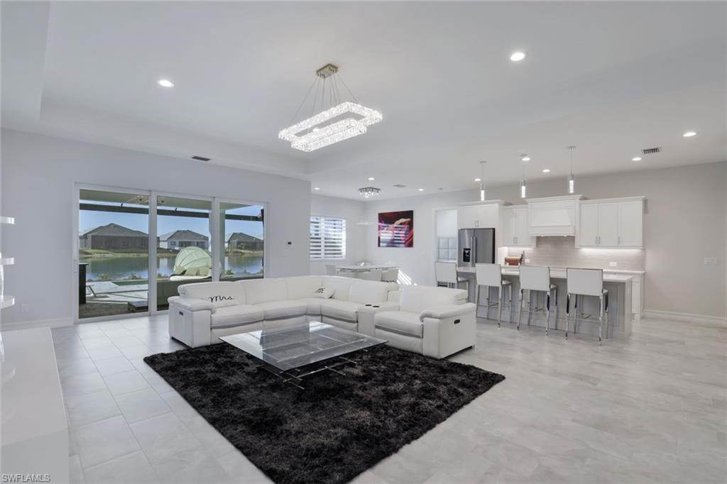 14327 Laguna Springs Lane Naples, FL 34114 - Photo 6 of 35 a living room with lots of furniture and a table