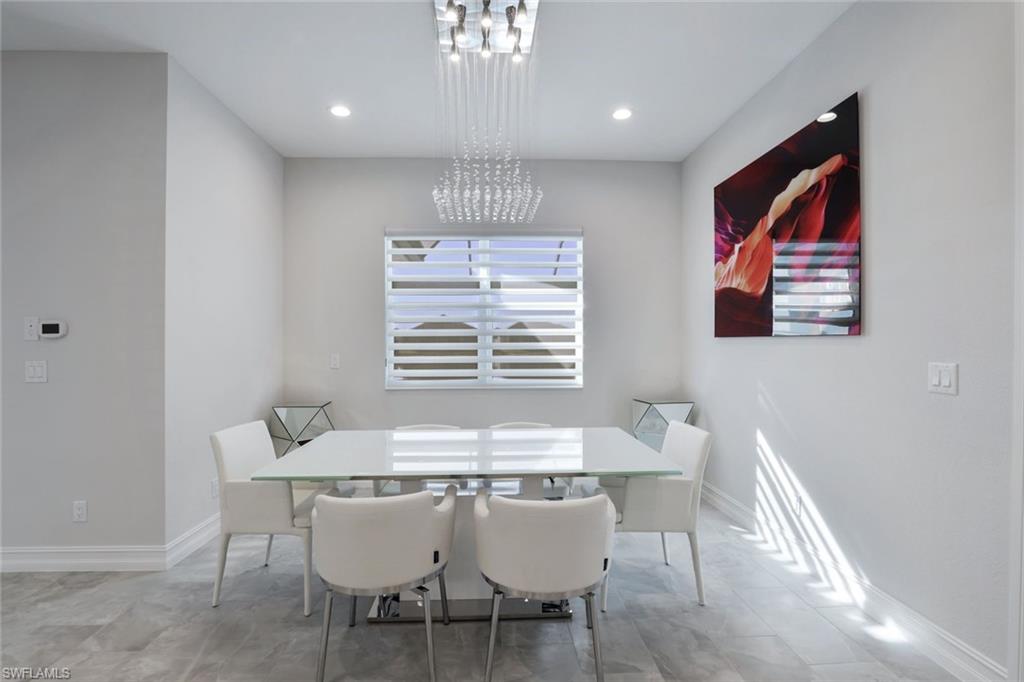 14327 Laguna Springs Lane Naples, FL 34114 - Photo 8 of 35 a dining room with furniture and window