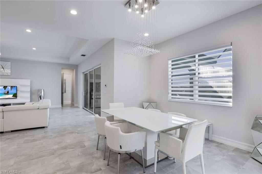 14327 Laguna Springs Lane Naples, FL 34114 - Photo 9 of 35 a view of a dining room with furniture and window