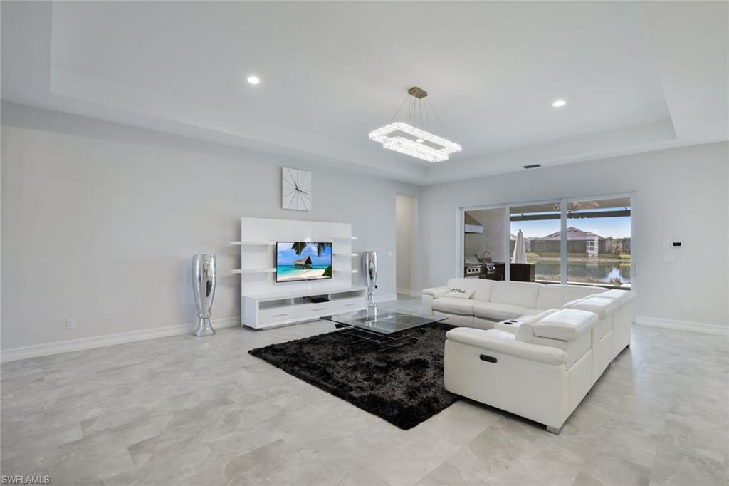 14327 Laguna Springs Lane Naples, FL 34114 - Photo 10 of 35 a living room with furniture and a large window