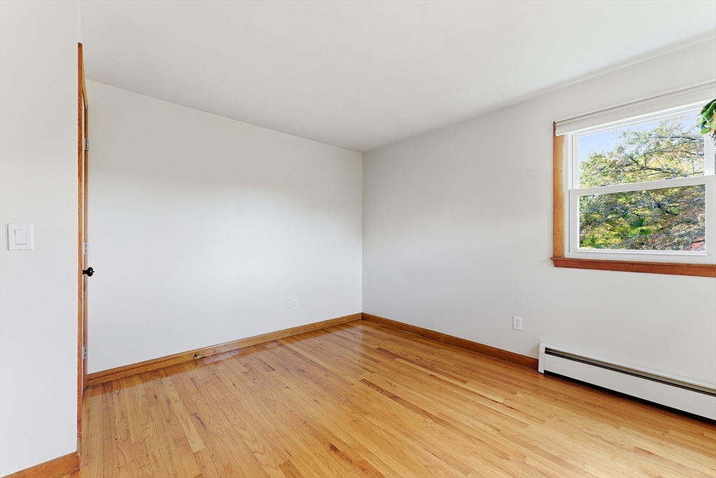 97 Mountain Road Holyoke, MA 01040 - Photo 16 of 27 a view of an empty room with wooden floor and a window