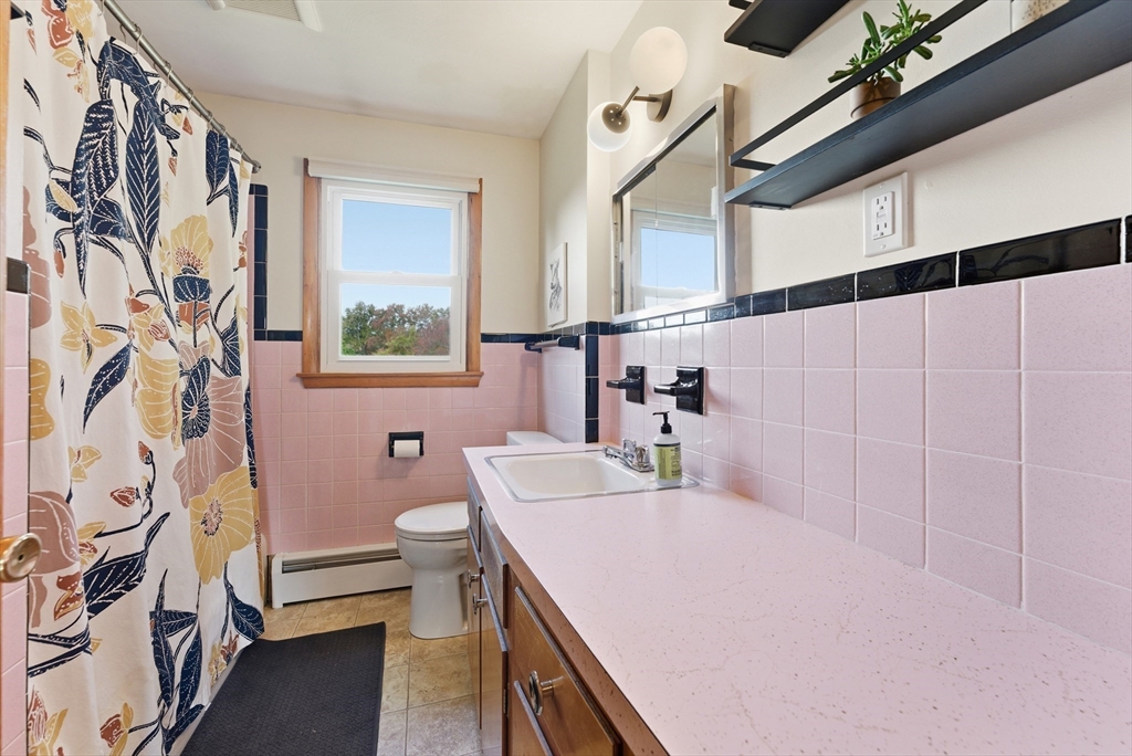97 Mountain Road Holyoke, MA 01040 - Photo 18 of 27 a bathroom with a sink a toilet and a mirror