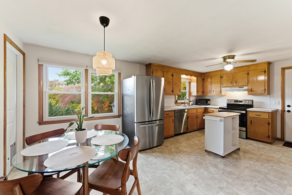 97 Mountain Road Holyoke, MA 01040 - Photo 8 of 27 a kitchen with refrigerator a stove and chairs