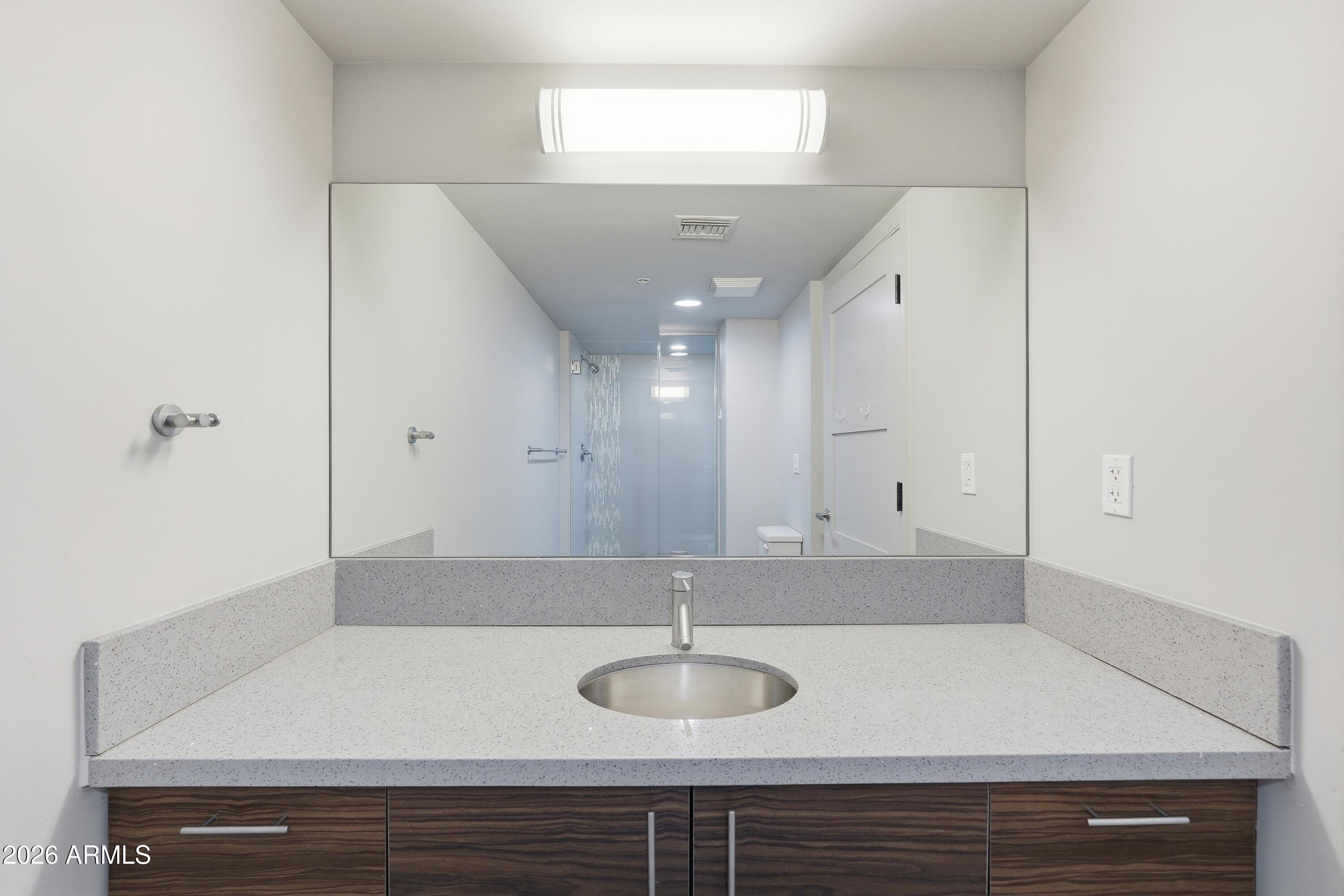 535 West Thomas Road, Unit 210 Phoenix, AZ 85013 - Photo 26 of 40 a bathroom with a sink and a mirror