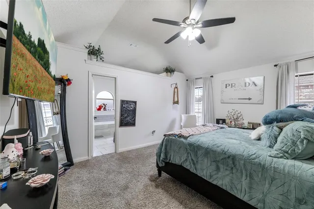 a bedroom with a bed closet and a flat tv screen
