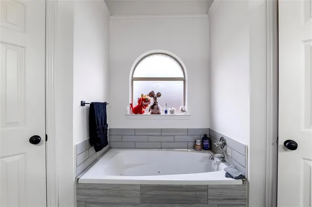 a bathroom with a tub and a window