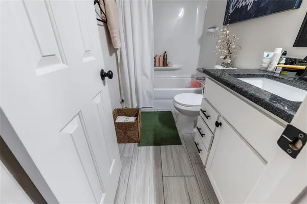 a bathroom with a sink a toilet and a shower
