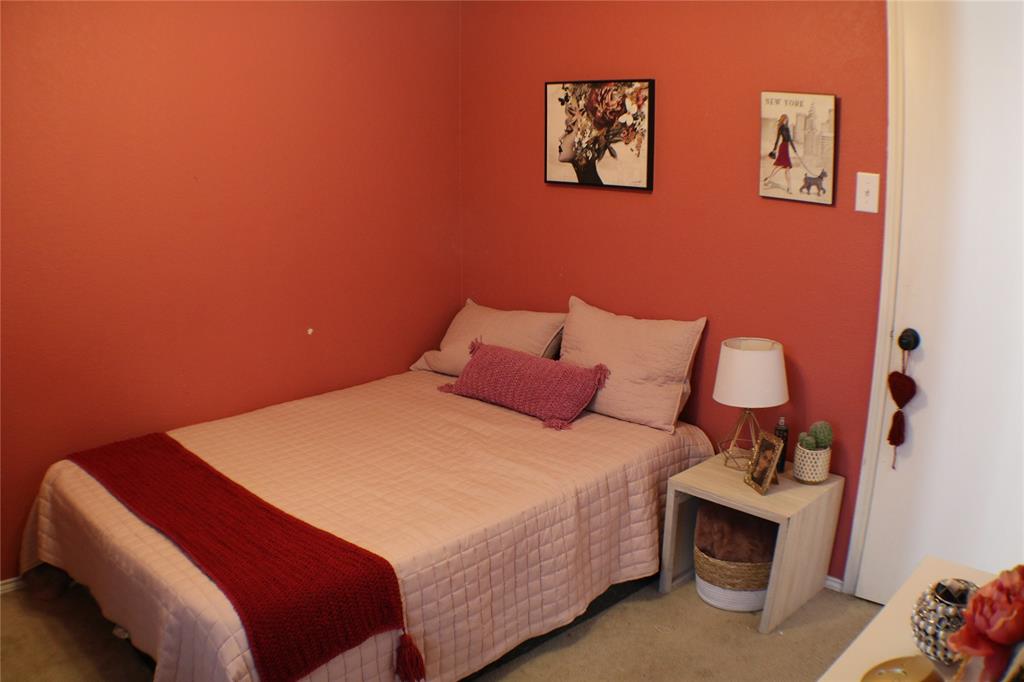 173 West Ranch Lane Weatherford, TX 76088 - Photo 17 of 29 a bedroom with a bed and a lamp on dresser