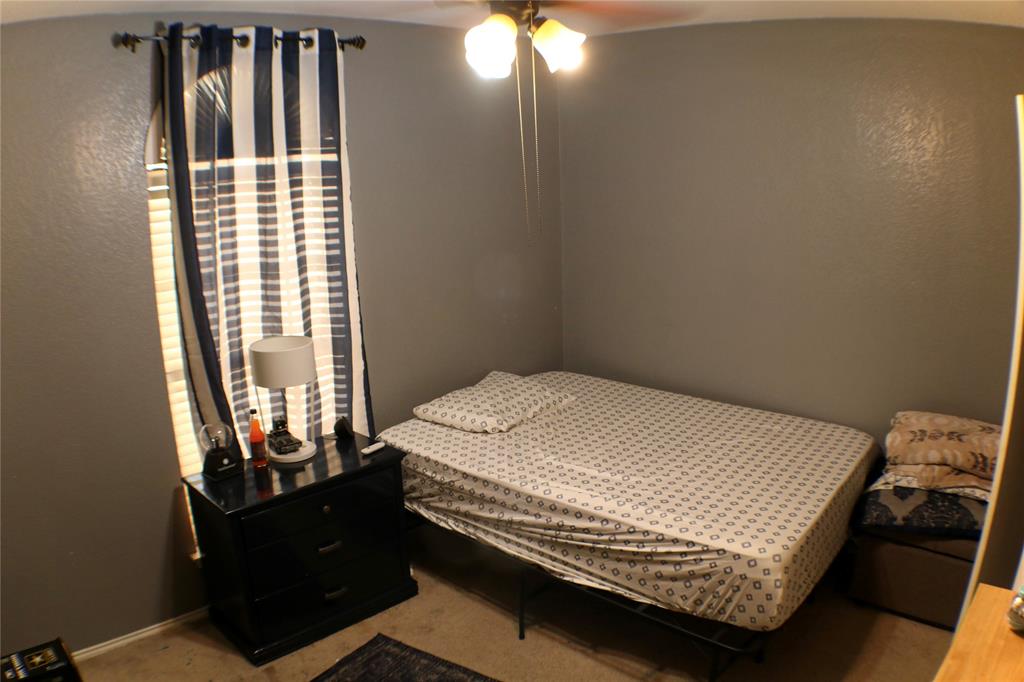 173 West Ranch Lane Weatherford, TX 76088 - Photo 20 of 29 a bed sitting in a bedroom next to a window
