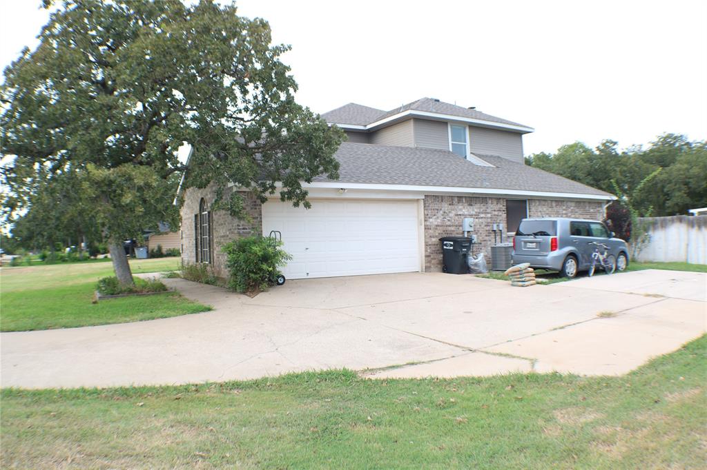 173 West Ranch Lane Weatherford, TX 76088 - Photo 23 of 29 front view of house with a yard and potted plants