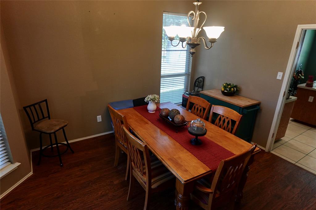 173 West Ranch Lane Weatherford, TX 76088 - Photo 5 of 29 a view of a dining room with furniture and wooden floor