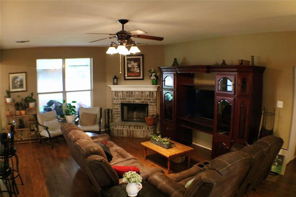 173 West Ranch Lane Weatherford, TX 76088 - Photo 8 of 29 a living room with furniture a fireplace and a flat screen tv