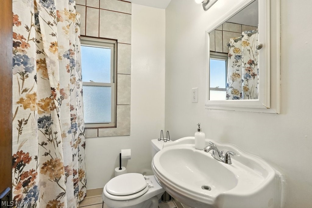 3579 Bosworth Road Cleveland, OH 44111 - Photo 36 of 39 Bathroom featuring a pedestal sink, wall-mounted mirror, and a window with tiled surround